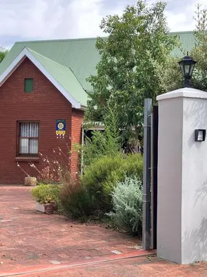 a red brick building with a electrical box in front of it at Starry Starry Night Loft, with Aircon in Die Boord in Stellenbosch