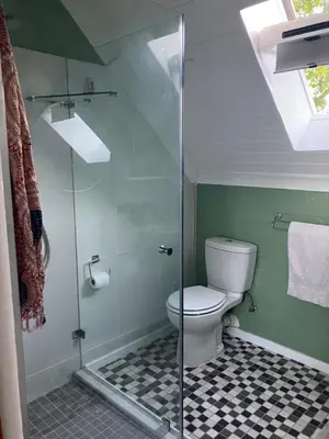 a bathroom with a toilet and a glass shower at Starry Starry Night Loft, with Aircon in Die Boord in Stellenbosch