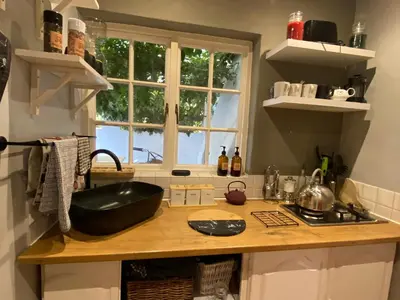 a kitchen with a counter with a black bowl on it at Maggie Rose Self Catering Cottage in Greyton