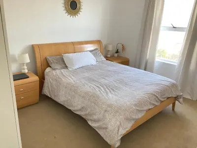 a bedroom with a bed and a mirror on the wall at Polaris House in Cape Town