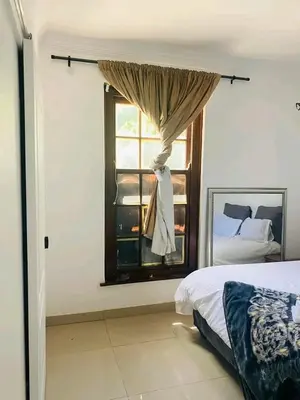 a bedroom with a bed and a window at Edion Royal Guesthouse in Cape Town