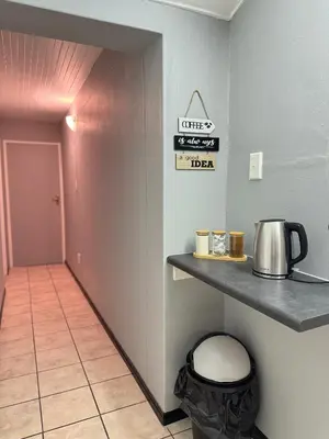 a room with a counter with a coffee pot on a shelf at Worcester Cozy Stay - Apto 1 in Worcester