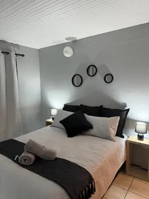 a bedroom with a bed and two clocks on the wall at Worcester Cozy Stay - Apto 1 in Worcester