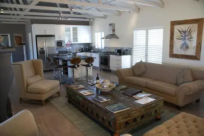 a living room with a couch and a table at Wedgeview Country House & Spa in Stellenbosch