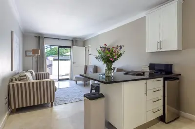 a kitchen with a desk with a vase of flowers at Wedgeview Country House & Spa in Stellenbosch