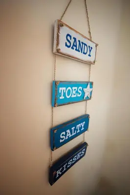 a group of street signs hanging on a wall at Silencio in Hermanus