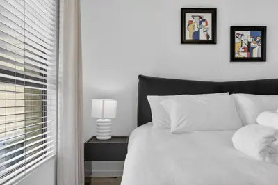 a bedroom with a white bed and a window at Modern Luxury 2BR Island Club Century City in Cape Town