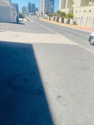 a shadow of a pole on a street at Cape Coral in Cape Town