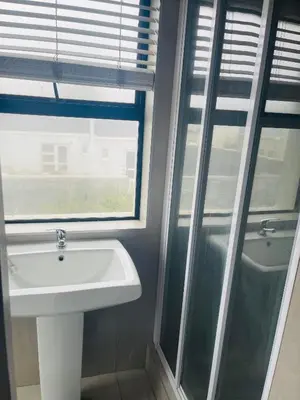 a bathroom with a sink and a window at Cape Coral in Cape Town