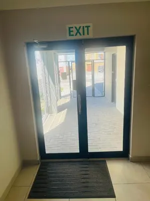 an exit door in a building with a sign on it at Cape Coral in Cape Town