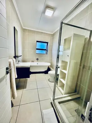 a bathroom with a tub and a toilet and a sink at Cape Town Apartment with Table Mountain View in Cape Town