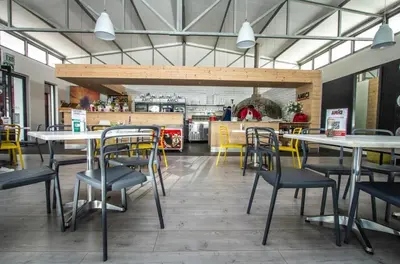 a dining room with tables and chairs in a restaurant at Cape Town Apartment with Table Mountain View in Cape Town