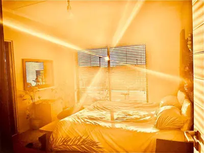 a bedroom with a bed in a room with a window at Cape Town Apartment with Table Mountain View in Cape Town