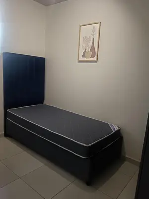 a bed in a room with a picture on the wall at Belhar Lofts in Belhar
