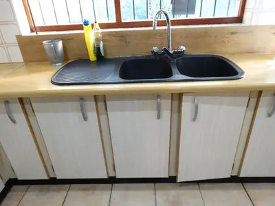 a kitchen counter with a sink and a window at African Oasis Morrocco in Somerset West