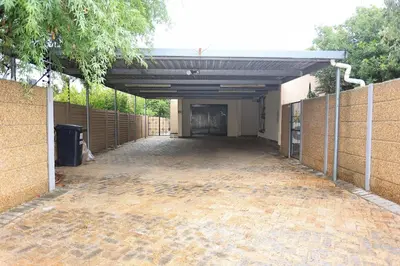 an empty parking lot of a building with a garage at African Oasis Morrocco in Somerset West