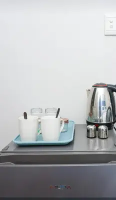 a counter with two cups and a tea kettle at African Oasis Cameroon in Somerset West