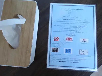 a menu with a piece of paper sticking out of a box at African Oasis Kenya in Somerset West