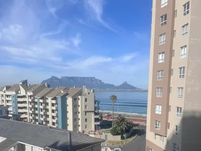 a view of the ocean from a building at Aquarius Luxury Suites 406 in Cape Town
