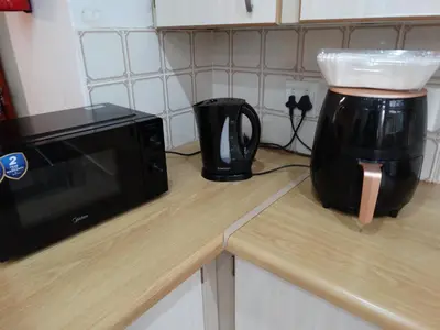 a microwave sitting on a counter next to a coffee maker at African Oasis Zambia in Somerset West