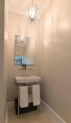 a bathroom with a sink and a chandelier at Fifty9 in Somerset West