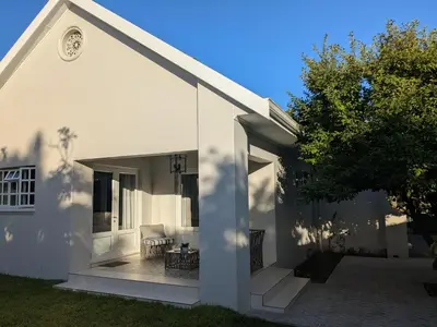 a white house with a large open patio at Fifty9 in Somerset West