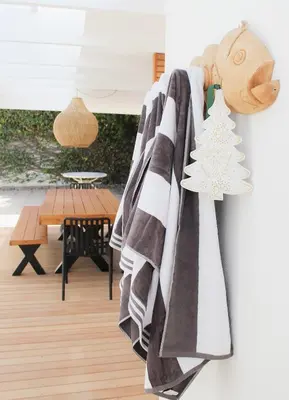 a towel hanging on a wall in a living room at Endless summer in Hermanus