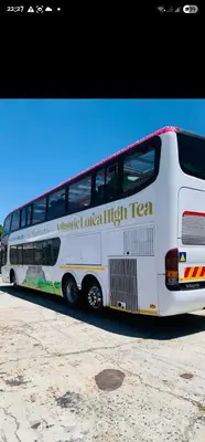 a white bus parked on the side of the road at Atlantic Lorea hight Tea in Cape Town