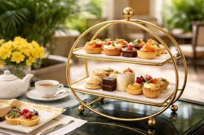 a display of deserts and pastries on a table at Atlantic Lorea hight Tea in Cape Town