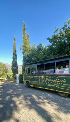 a green bus filled with people sitting in it at Elevené - one bedroom cottage with private pool in Franschhoek