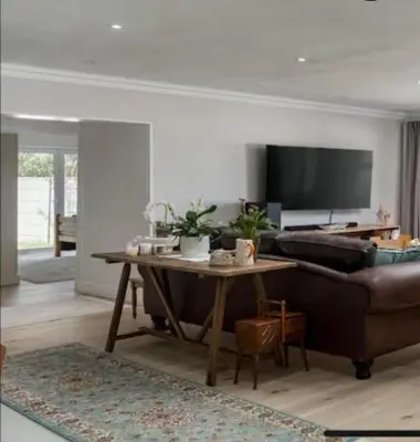 a living room with a couch and a table at Sues Suite in Somerset West