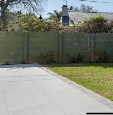 a yard with a fence and a sidewalk in front at Sues Suite in Somerset West