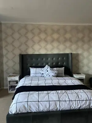 a bedroom with a large bed and two night stands at Sleep easy at Peperboom in Kuilsrivier