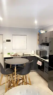 a kitchen with a table and chairs in it at Smart and elegant space in Cape Town