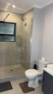 a bathroom with a toilet and a shower at Smart and elegant space in Cape Town