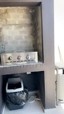 a kitchen with a stove and a trash can at Smart and elegant space in Cape Town