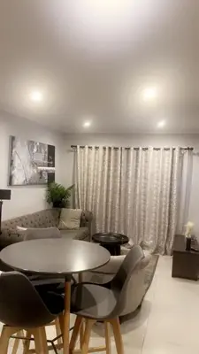 a living room with a table and chairs at Smart and elegant space in Cape Town