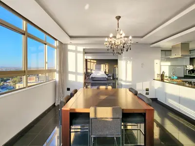 a kitchen and dining room with a table and chairs at Bird's View in Cape Town