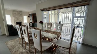 a dining room with a table and chairs at KwaNolz in Cape Town