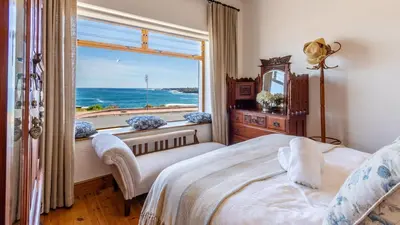 a bedroom with a window with a view of the ocean at 59 Marine Hermanus in Hermanus