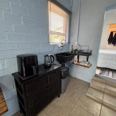 a bathroom with a black sink and a counter with a sink at Sea Breeze in Strand