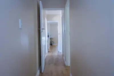 a hallway with an open door to a room at 5BR Pool Fast Wi-Fi Walk To The Beach Pool Table in Cape Town