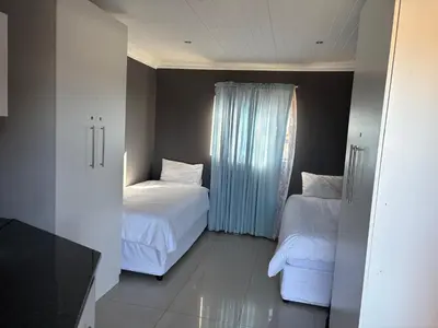 a bedroom with two beds and a window at SNE Travellers in Faure