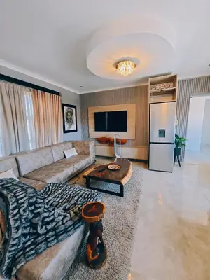 a large living room with a couch and a table at Beachwalk luxury one bedroom apartments in Cape Town