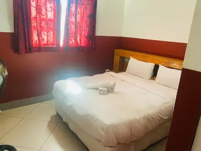 a bedroom with a bed with a towel on it at Prince Adina Guesthouse in Tiervlei