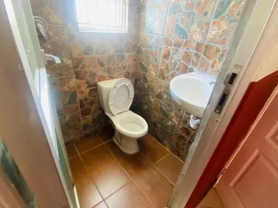 a bathroom with a toilet and a sink at Prince Adina Guesthouse in Tiervlei