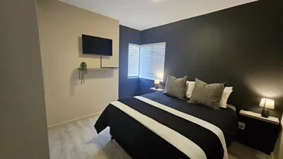 a bedroom with a large bed with a blue wall at Her Sanctuary in Cape Town