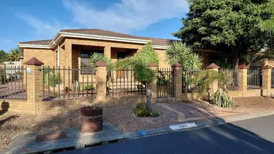 a brick fence in front of a house at Waaigras in Brackenfell