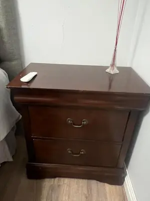 a wooden dresser with a remote control on top of it at Oryx guest house in Oakdale