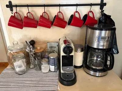 a kitchen counter with a coffeemaker and a coffee maker at Peaceful coastal holiday home in Hermanus